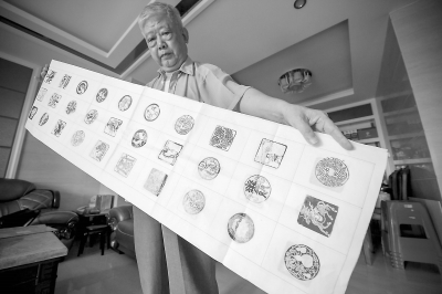 楊堅(jiān)水展示準(zhǔn)備捐贈(zèng)的作品。