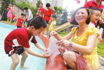 市第二幼兒園孩子與家長一起玩抓泥鰍。