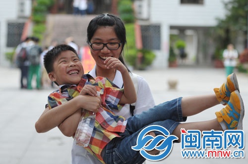 在泉州五中門口，一名考生將在考場(chǎng)外等候的弟弟抱起