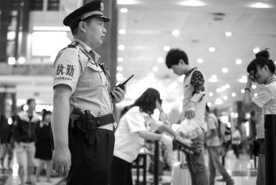 鐵路民警在北京站內(nèi)巡邏，腰間佩帶著警用轉(zhuǎn)輪手槍