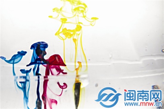 畫(huà)筆剛接觸水面，顏色在透明的水里散開(kāi)，像是一只只