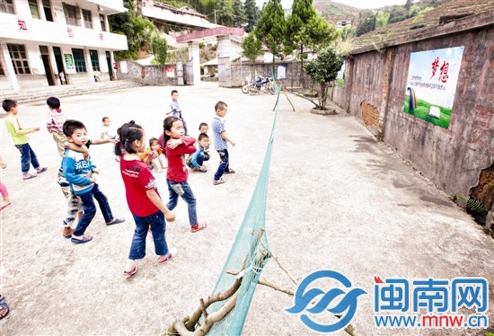 幾名小學生在操場上玩，學校的圍墻歪了一邊，用簡易