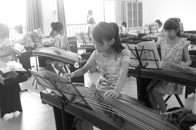孩子們正在認(rèn)真學(xué)古箏。